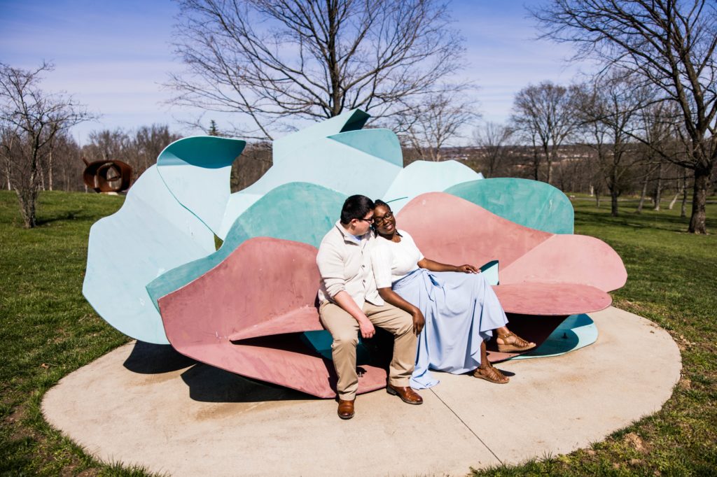 Kenny and Jonathan sitting on a bench-like sculpture