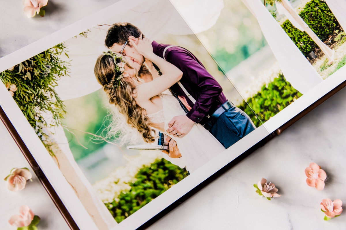 A detail photo of a wedding album from two wedding photographers giving planning tips