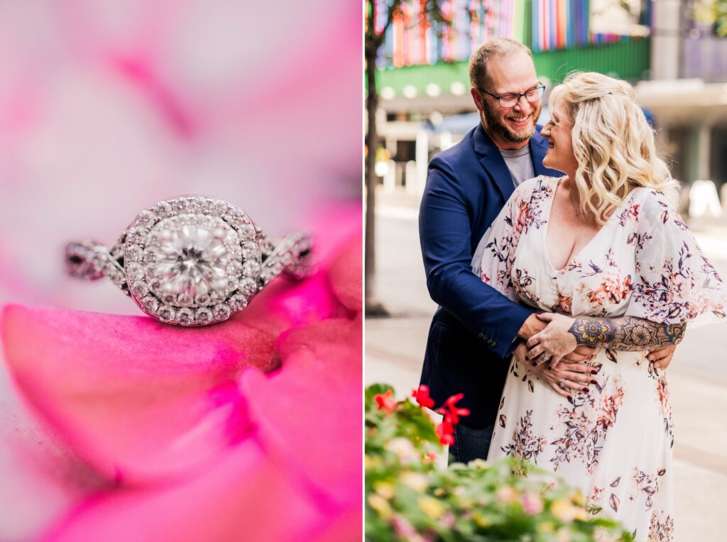 Engagement ring sitting on pink flower paired next two an engaged couple hugging on the streets of downtown Cincinnati