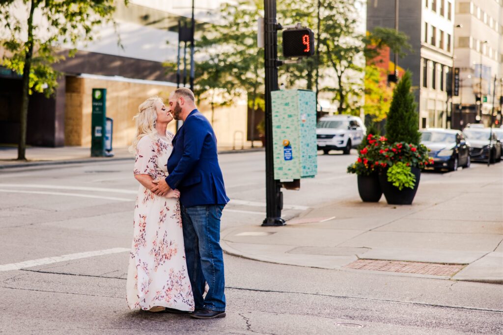 Engaged couple kissing in the walkway of downtown Cincinnati for engagement photo