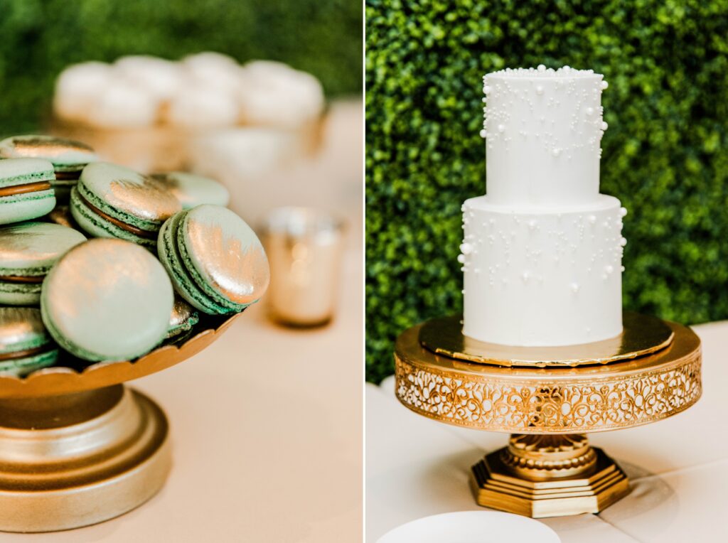 Wedding dessert table with a white cake and green and gold macrons
