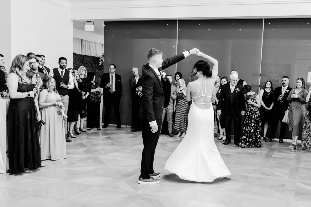 Groom twirling his bride during their first dance