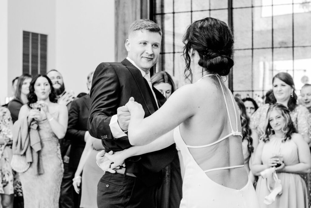 Groom smiling at the bride during their choreographed first dance
