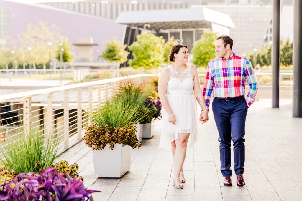 Couple walking along flower pots at Smale park cincinnati Oh during sunset