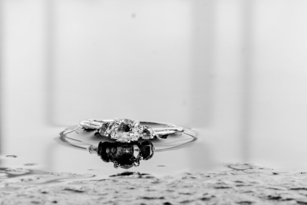 close up of engagement ring sitting in water