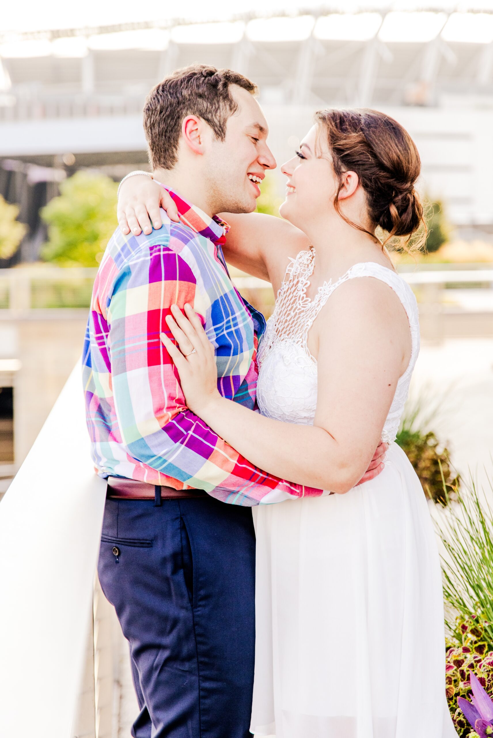 Engaged couple embracing in a hug smiling at each other at Smale Park